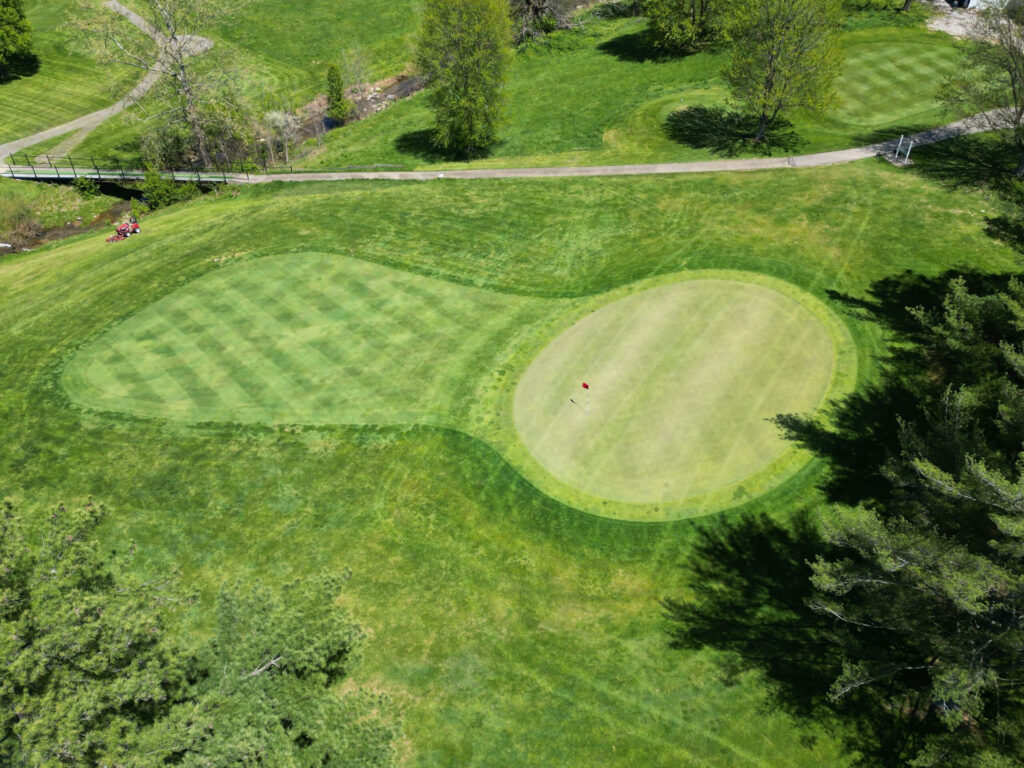 Well-manicured approach and green on a bright, sunny day.